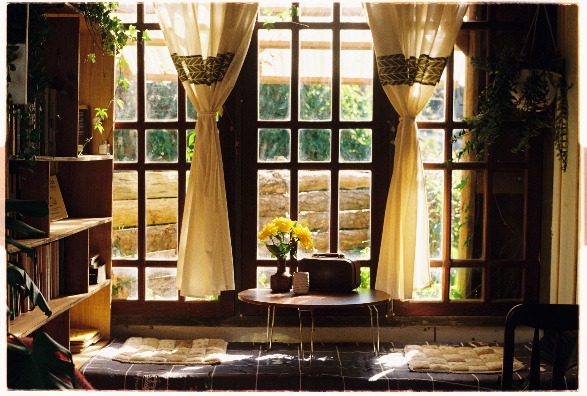 A warm and inviting living room with large windows and natural light — calm and welcoming